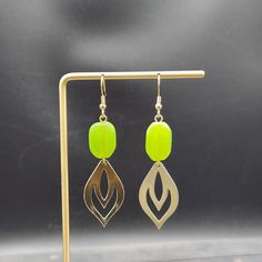 "These dangle earrings feature 30mm x 18mm plated brass leaf charms dangling from 18mm chartreuse or lime green lampwork glass oval beads. These geometric earrings transition effortlessly from office wear to street wear, and are lightweight enough to wear all day. These earrings measure approximately 2.75 inches from the bottom of the teardrop to the top of the ear wires, which are made of hypoallergenic gold-plated surgical steel, making these statement earrings safe for sensitive ears. They're fairly lightweight, weighing approximately 0.15 ounces each.  Domestic shipping is always free here at MayaMadeThis! Check out my other brass jewelry here: https://etsy.me/2JuMNi2 When will my item ship? Every single item here at MayaMadeThis is made to order, meaning I make it especially for you a Green And Gold Earrings, Green Dangle Earrings, Oval Beads, Earrings Green, Leaf Charms, Green Earrings, Silver Spring, Brass Jewelry, Geometric Earrings