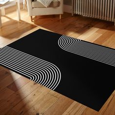 a black and white rug on the floor in front of a chair with a radiator