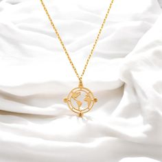 ✨ Handmade 14K Gold Compass Pendant Necklace ✨ Embrace your wanderlust with this elegant Gold Compass Pendant Necklace, the perfect accessory for travel enthusiasts and minimalists alike. Crafted with exquisite attention to detail, this necklace features a world map design encircled by a compass, symbolizing adventure, exploration, and a love for new journeys. This travel-inspired necklace makes a thoughtful gift for birthdays, anniversaries, or as a keepsake for a memorable trip. Perfect for ad Compass Pendant Necklace, Travel Inspired Jewelry, World Map Necklace, World Map Design, Travel Necklace, Compass Pendant, A Compass, Compass Necklace, Map Necklace