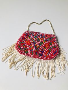 "This is a fun vintage pouch embellished with bright and colorful plastic beadwork. Measurements: Length - 6\" Height - 4\" + 2.5\" strands Chain - 9\" All of my items come from a smoke-free and pet-free home. If you have any questions, please don't hesitate to ask!" Vintage Beaded Bags For Festival, Festive Multicolor Beaded Bag, Beaded Coin Purse, Checkered Jacket, Bead Sewing, Beaded Handbag, Vintage Couture, Beaded Gown, 80s Retro