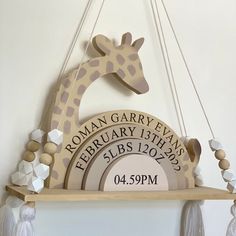 a wooden giraffe hanging from the side of a wall