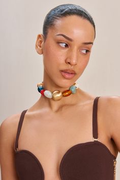 An assorted bead choker necklace with a gold-toned adjustable chain. — Assorted beads — Choker length — Lobster clasp — Gold-toned chain Trendy Gold Jewelry With Large Beads, Adjustable Large Beads Choker Jewelry, Adjustable Large Bead Choker Jewelry, Adjustable Large Beaded Choker Jewelry, Bead Choker Necklace, Beads Choker, Bead Choker, Beaded Choker Necklace, Beaded Choker