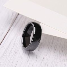 a black ring sitting on top of a white table