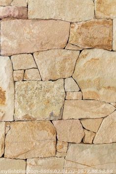 a stone wall that is made out of different types of rocks and has been used as a background