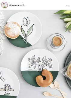 three plates with flowers painted on them, one has a donut and the other has a cup of coffee