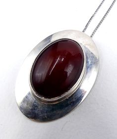 "Vintage marked Nakai sterling silver and dark red cabochon pendant necklace, In good vintage condition. The chain 17\" ½ long. Pendant 1\" 5/8 long 1\" 1/8 wide, Dark red cabochon 24 mm x 17 mm. Weighs 12.5 gram. Thanks." Vintage Hallmarked Oval Cabochon Necklace, Red Vintage Necklace With Cabochon, Vintage Red Cabochon Necklace, Red Oval Pendant Vintage Necklace, Vintage Red Oval Pendant Necklace, Red Vintage Cabochon Necklace, Red Vintage Oval Pendant Necklace, Red Necklace With Large Pendant For Formal Occasions, Formal Red Necklace With Large Pendant