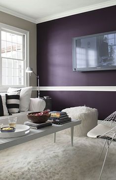 a living room filled with furniture and a flat screen tv