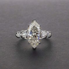 an oval cut diamond ring with baguettes on the sides and tapered shoulders