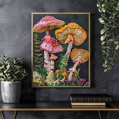 two mushrooms are in the middle of some plants and flowers on a black wall next to a potted plant