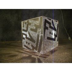 a lit up cube sitting on top of a table