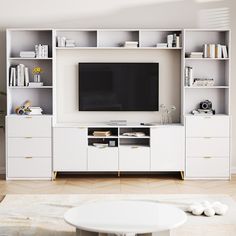 a living room with white furniture and a flat screen tv