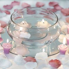 candles floating in a bowl with petals around it