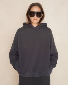 Hooded Stockholm sweater by Acne Studios in black. Unisex relaxed hoodie crafted from a fleece cotton blend, featuring sprayed finish for vintage effect. Minimal construction with dropped shoulders, side pockets and a cordless hood. Typically Acne weathered styling with the Stockholm stamp logo at the rear and distressed cuff and hem detailing. 89% Cotton, 11% Polyester.Made in Portugal. Pictured with Davis Temple Sunglasses by Rick Owens and Tabi Sneakers by Maison Margiela. Stockholm Sweater, Tabi Sneakers, Stamp Logo, Vintage Effect, Rick Owens, Black Sweaters, Stockholm, Temple, Acne Studios