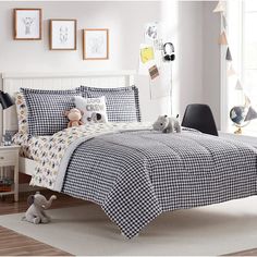 a child's bedroom with black and white checkered bedding, toys and pictures on the wall