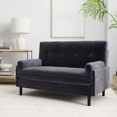 a living room with a gray couch and white rug