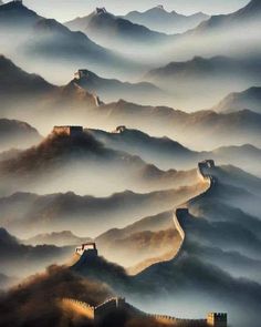 an aerial view of the great wall of china with fog in the valley and mountains