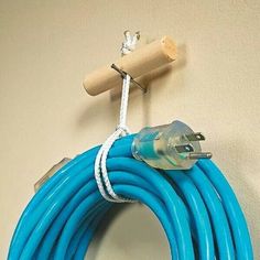 a blue hose is hanging on the wall