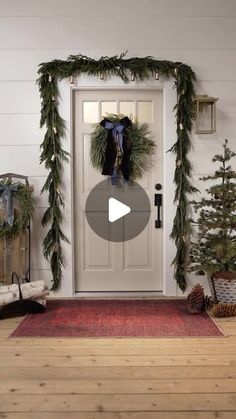 the front door is decorated for christmas with wreaths and garland