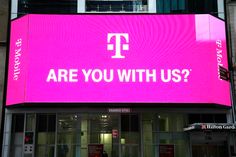 a large pink sign that says are you with us?