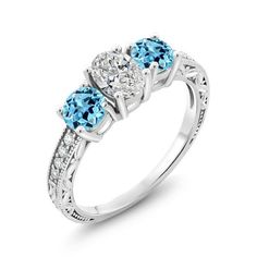 three stone engagement ring with blue topaz and white diamonds on the sides, set in 18k white gold