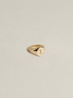 An ultra-petite version of our classic, engravable JH signet ring—interpreted in charm form. Our Baby Signet Charm has an 8mm interior diameter with a signet face that measures 5mm x 6mm. Crafted in 100% recycled 14k gold or sterling silver and available à la carte, paired with a chain (cable, figaro, or curb), or with one of our signature Charm Chains (curb, paperclip) in a length of your choosing. We offer two engraved font options for personalization: laser engraved J.H. Gothic (our entirely Classic Rose Gold Signet Ring Stamped 14k, Elegant 14k Gold Initial Ring With Engraving Option, Classic Gold Initial Ring For Everyday, Personalized Timeless Rings For Everyday, Classic Everyday Initial Ring, Timeless Personalized Rings, Timeless Everyday Personalized Rings, Everyday Personalized Timeless Rings, Everyday Sterling Silver Signet Ring