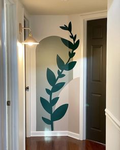 an empty hallway with a painted wall and wooden floors in front of the door is a doorway