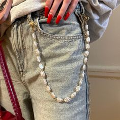 This Pearl jeans chain is the hot fashion accessories. The 19,5" lengths belt chain doubles as a bag chain that will add a touch of elegance to any outfit.  Key Features: - Can be used as a Perl belt chain, bag chain, necklace, mobile phone accessories or keychain - Pearls matches with any outfit - Perfect gift for moms or friends Made with high-quality faux pearl beads and gold plated materials, this Pearl jeans belt is durable and long-lasting. It's the perfect addition to your collection of f Chain On Jeans Outfit, Pant Chains Aesthetic, Wallet Chain Outfit, Chain Jeans Outfit, Keychain Pearls, Chain For Jeans, Jean Chains, Chain Belt Outfit, Belts Aesthetic