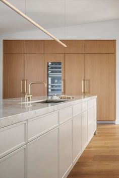 a kitchen with white counter tops and wooden cabinets