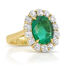 If you love mouth-watering emeralds as much as I do, please brace yourself now. This delicious one-of-a-kind gem is the most beautiful shade of green. The sparkly mine cut diamonds frame this magnificent statement ring perfectly. Don't forget to get a fresh manicure because the attention will be all over you and your new ring. Available in 18k yellow gold 6.27ctw natural Brazilian emerald 4.72ctw mine cut diamonds The face measures approximately 16.9mm x 18mm By Curated by AB Oval Emerald Ring With Pave Diamond Setting, Oval Emerald Ring With Diamond Pave Setting, Oval Emerald Rings With Pave Setting, Green Emerald Diamond Ring With Pave Setting, Formal Emerald Ring With Halo Setting, Formal Emerald Halo Ring Fine Jewelry, Oval Green Diamond Gemstones, Brilliant Cut Oval Diamond Ring With Tsavorite, Luxury Emerald Gemstones With Prong Setting