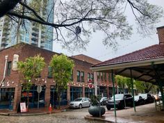 cars are parked in front of an old brick building