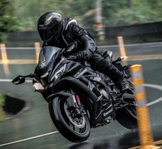 a man riding on the back of a black motorcycle