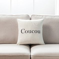 a couch with two pillows that say coucu on the front and back sides