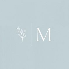 the letters m and m are in white on a light blue background, with leaves