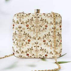 Beige and Gold embroidered clutch in Exclusive Ogee Pattern on a Faux Silk Fabric. The meticulous craftsmanship includes intricate embroidery details, adding a touch of elegance to any ensemble. Designed with practicality in mind, it provides versatility, allowing you to carry it as a stylish handbag or use it as a statement clutch. This fashion-forward accessory seamlessly combines functionality with aesthetics, making it a must-have for special occasions or adding a touch of glamour to your ev Embellished Cream Rectangular Clutch, Cream Embellished Rectangular Clutch, White Embroidered Rectangular Evening Bag, Embroidered Multicolor Clutch For Evening, Formal White Embroidered Clutch, Embroidered Cream Clutch For Evening, Embroidered Cream Evening Bag For Party, Festival Bags With Floral Embroidery, Festival Bags With Floral Embroidery For Reception