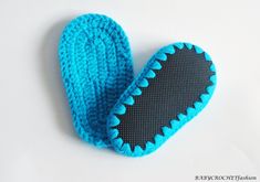 a blue crocheted mitt laying on top of a white table next to a pair of scissors