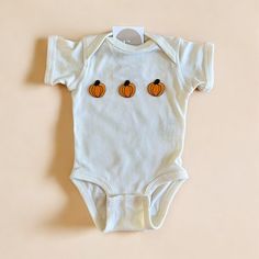 The cutest pumpkin baby outfit for this fall season! Makes the perfect outfit for fall baby photos, pumpkin patch and more. Available for the whole family also!  Please be mindful that we do not accept RETURNS / EXCHANGE / ORDER CANCELLATIONS in any way because this is made to order. We are also open for wholesale/bulk orders, kindly send us a message! Handmade in Chicago. Support small businesses. Shop small. ♡ Playful Cotton Onesie For Fall, Playful Fall Cotton Onesie, Cotton Onesie For Playtime In Fall, White Cotton Onesie For Fall, Cute White Onesie For Fall, Fitted White Onesie For Fall, Baby Pumpkin Patch Outfit, Baby Pumpkin Patch, Baby Pumpkin Outfit