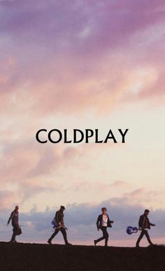 four people walking down a hill with the words coldplay in front of them,