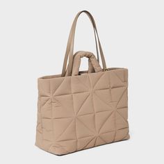 This Kate Tote Handbag from A New Day™ in a solid color showcases an unstructured silhouette with a geometric quilted finish for a chic, textured look and it goes well with any of your outfits. The interior accessories pocket, zip pocket and exterior side pockets help keep your belongings organized. Designed with a magnetic closure, this stylish tote handbag is easy to carry with double shoulder and grab handles. A New Day™: Style that goes wherever you do. Versatile Quilted Everyday Bag, Everyday Textured Tote Bag, Textured Tote Shoulder Bag For Travel, Textured Travel Tote Shoulder Bag, Beige Quilted Shoulder Bag For Shopping, Modern Quilted Shoulder Bag For Everyday, Versatile Quilted Beige Bag, Modern Quilted Everyday Shoulder Bag, Chic Everyday Bag With Geometric Shape