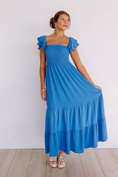 - Say hello to summer maxi vibes with this beautiful dress! - Unlined material - A square cut neckline - Elastic flutter sleeves - A smocked bodice - A flowy yet flattering silhouette that ends in a maxi length hemline Flowy Ruched Maxi Dress With Square Neck, Flowy Square Neck Ruched Maxi Dress, Beach Midi Dress With Ruched Square Neck, Blue Maxi Smocked Dress With Ruffles, Beach Smocked Dress With Ruffles And Square Neck, Beach Smocked Dress With Square Neck And Ruffles, Blue Square Neck Maxi Dress With Smocked Back, Blue Maxi Dress With Smocked Back And Square Neck, Square Neck Maxi Dress With Smocked Back For Brunch