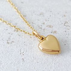 "Gold Heart Necklace, Gold Filled Puffy Heart, Tiny Heart Charm, Mothers Day Necklace, Valentines Heart Jewelry, Bridesmaid Gift, Love Necklace, FREE SHIPPING A shiny, smooth, high polished 14 karat gold filled puffy heart charm is suspended from your choice of box or petite cable chain. This necklace makes a charming flower girl gift, bridesmaid gift, birthday gift, or just to say I love you, and it is perfect for anyone for any occasion. OVERVIEW: * Beautiful, elegant, bright and sturdy 16, 18, or 20 inch 14 karat gold filled chain. Choose from a 0.85 mm 14K gold filled box chain or a 14K gold filled 1.2 mm fine cable chain *14 karat gold filled puffy heart charm, 10 mm length (12 mm with jump ring), 8 mm width *All components are 14 karat gold filled to include jump ring. *Gift box with Mothers Day Necklace, Heart Necklace Gold, Puffy Heart Charms, Golden Heart, Flower Girl Gifts, Gold Heart Necklace, Puffy Heart, Heart Shape Pendant, Tiny Heart