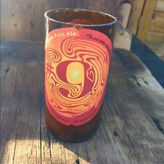 a glass sitting on top of a wooden table