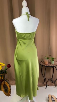 Midi dress Halter neck tie fastening Zipper fastening on the side 97% polyester 3% spandex Model is wearing a size small Color- green Fitted Mid-length Slip Dress For Spring, Fitted Mid-length Spring Slip Dress, Solid Color Spring Dresses For Night Out, Spring Solid Color Dresses For Night Out, Mid-length Slip Dress For Spring Parties, Spring Mid-length Maxi Dress For Night Out, Green Midi Dress For Brunch, Green Knee-length Slip Dress For Date Night, Chic Midi Slip Dress For Garden Party