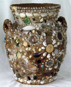 a vase made out of rocks and shells