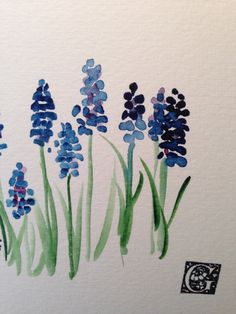 watercolor painting of blue flowers on white paper