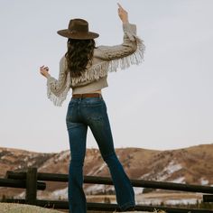 This cozy, wool-blend cable-knit cardigan sweater has a soft tan color, a front-button closure and stylish fringe accents at the back yoke and sleeves. Waist length, with longer, flowing sleeves, it offers easy elegance when worn with jeans, or a dash of bohemian flair when dressed up. Cable-Knit Fringe At Back Yoke And Sleeves Large Fold Down Collar Oversized Buttons 85% Acrylic, 15% Wool Imported Cozy Fringe Cardigan For Fall, Chic Fringe Sweater For Fall, Casual Fall Sweater With Tassels, Fall Tassel Long Sleeve Sweater, Western Tassel Outerwear For Fall, Beige Fringe Cardigan For Fall, Fall Beige Fringe Cardigan, Fall Long Sleeve Fringe Sweater, Knit Fringe Outerwear For Fall