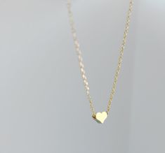 "Dainty necklace, gold Heart necklace, gold necklace, Dainty jewelry, gift for her, simple necklace, gift for women, dainty necklace, birthday gift for her Simple and dainty gold heart necklace. D E T A I L S: *5mm tiny gold plated heart *18\" gold plated chain *Lobster clasp closure This style is also available in rose gold and silver in our shop! SHIPPING: *Free domestic shipping on all orders PACKAGING: *All pieces come beautifully packaged, perfect for gift giving. Find more to ❤️ here: http Elegant Heart-shaped Simple Jewelry, 14k Gold Heart Necklace With Delicate Chain For Gift, Dainty Gold Plated Charm Necklace As Gift For Her, Simple Necklace With Heart Charm As A Gift, 14k Gold Filled Heart Pendant Necklace As Gift, Minimalist Heart Jewelry With Simple Design, Minimalist 14k Gold Filled Necklaces With Heart Charm, Minimalist 14k Gold Filled Heart Pendant Necklace, Minimalist Heart Shaped Jewelry With Simple Design