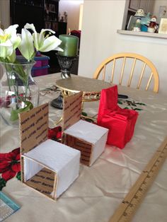 the table is covered with boxes and flowers