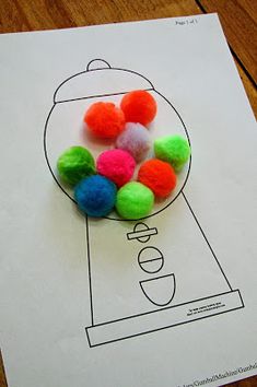 a gumball machine is on top of a piece of paper