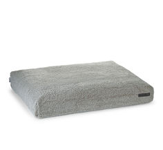 a gray dog bed on a white background