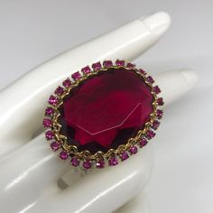 Badgley Mischka Ring With Massive Stone Surrounded By Fuchsia Crystals . If You Are Searching For A Statement Ring - This Is The One . Comes With A Tag Attached . Never Worn . In Very Good Condition . Glamorous Evening Ring Jewelry, Oval Ruby Ring For Party, Oval Ruby Ring For Parties, Party Ruby Gemstone Rings, Party Rings With Jewels, Ruby Rings For Party, Fine Jewelry Style, Ruby Party Ring, Crystal Jeweled Party Rings, Elegant Jeweled Rings For Party